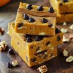 To make these tasty no-bake pumpkin spice protein bars, you need: - 1 cup rolled oats - 1/2 cup vanilla protein powder - 1/2 cup pumpkin puree - 1/4 cup nut butter (such as almond or peanut) - 1/4 cup honey or maple syrup - 1 teaspoon pumpkin pie spice - 1/2 teaspoon cinnamon - 1/4 cup chopped nuts or seeds (e.g., walnuts, sunflower seeds) - 1/4 cup dark chocolate chips (optional) - Pinch of salt Each bar provides a good source of protein and healthy fats. Here’s a quick breakdown: - Calories: About 150 - Protein: 6-8 grams - Carbs: 20 grams - Fiber: 3 grams - Sugars: 5 grams (if using honey) These bars make a great snack or quick breakfast. They are filling and nutritious! You can easily swap out some ingredients if needed. Here are some ideas: - Use chocolate protein powder instead of vanilla for a richer taste. - Swap pumpkin puree for sweet potato puree if you prefer that flavor. - Almond butter can be replaced with sunflower seed butter for nut-free options. - Use agave syrup or brown rice syrup instead of honey or maple syrup for vegan bars. - If you want more crunch, try adding sunflower seeds or pumpkin seeds instead of nuts. Feel free to get creative! These bars are versatile and fun to make. To make these no-bake pumpkin spice protein bars, you need a few simple steps. First, gather all your ingredients. This will help keep your cooking fun and smooth. You will need rolled oats, protein powder, pumpkin puree, nut butter, honey or maple syrup, pumpkin pie spice, cinnamon, chopped nuts or seeds, dark chocolate chips, and salt. Start by taking a large mixing bowl. Add 1 cup of rolled oats, 1/2 cup of protein powder, 1 teaspoon of pumpkin pie spice, 1/2 teaspoon of cinnamon, and a pinch of salt. Mix these dry ingredients well. In another bowl, combine 1/2 cup of pumpkin puree, 1/4 cup of nut butter, and 1/4 cup of honey or maple syrup. Stir until you have a smooth mixture. Now, pour the pumpkin mix into the dry ingredients. Stir everything together until the mixture is thick and sticky. Finally, fold in 1/4 cup of chopped nuts and 1/4 cup of dark chocolate chips if you want some extra sweetness. Next, line an 8x8 inch baking dish with parchment paper. This step helps to prevent sticking. Transfer your thick mixture into the dish. Press it down firmly. You can use your hands or the back of a spatula to make it even. Once it is flat, place the dish in the fridge. Let it chill for at least 1 to 2 hours. This step is key for the bars to become firm. After they set, lift the bars out using the parchment paper. Now, cut them into your favorite shapes. Enjoy your tasty, healthy treat! To get the best texture for your no-bake pumpkin spice protein bars, you need a few key tips. First, use rolled oats, as they give a nice chewiness. If you want a softer bar, add a bit more pumpkin puree. If you prefer a firmer bar, use a little less nut butter. The mix should be thick and sticky but not too wet. Press the mixture firmly into your dish. This helps the bars hold their shape when cut. Chill them for 1-2 hours. This cooling time firms them up nicely. I’ve seen some common mistakes when making these bars. One big mistake is not measuring the ingredients accurately. Use measuring cups for best results. Another mistake is not mixing the wet and dry ingredients well. They need to blend fully for the right flavor and texture. Also, avoid skipping the chilling step. If you cut them too soon, they may fall apart. Finally, don’t forget to use parchment paper in your dish. This makes it easy to lift the bars out later. These bars are great as a snack, but you can make them even better. Try stacking them on a wooden board for a nice display. Drizzle some extra nut butter on top for a tasty touch. A sprinkle of cinnamon adds flavor and looks nice too. You can also serve them with yogurt or fruit for added taste. These bars are perfect for a quick breakfast or a post-workout snack. Enjoy them with friends or keep them all to yourself! {{image_2}} You can switch up the flavors in these bars. Try using chocolate protein powder for a rich taste. Vanilla works well too, giving a nice base. If you want a fruity twist, add mashed banana instead of pumpkin. You can also mix in some peanut butter for a nutty flavor. Making these bars vegan is easy. Replace honey with maple syrup. Use any plant-based protein powder. For gluten-free bars, choose certified gluten-free oats. Check your nut butter for gluten-free labels. These tweaks keep the bars tasty while meeting dietary needs. You can personalize your bars with fun mix-ins. Add dried fruit, like cranberries or raisins, for sweetness. Chopped dates give a chewy texture. Seeds like chia or flax add crunch and nutrition. If you love chocolate, toss in more dark chocolate chips. Be creative and mix what you enjoy! To keep your no-bake pumpkin spice protein bars fresh, store them in an airtight container. This helps prevent them from drying out. Place the bars in the fridge for the best results. If you stack them, use parchment paper between layers to avoid sticking. This simple method keeps the bars tasty and ready to eat. You can also freeze these bars for longer storage. Wrap each bar in plastic wrap or foil. Then, place them in a freezer-safe bag or container. When you want a bar, take it out and let it thaw in the fridge. It takes about an hour to soften up. You can enjoy a delicious snack anytime! These protein bars last about a week in the fridge. If you freeze them, they can keep for up to three months. To check freshness, look for any off smells or changes in texture. If they seem dry or crumbly, it's time to toss them. Always trust your senses when it comes to food safety. Yes, you can use different protein powders. I suggest trying whey, plant-based, or hemp protein. Each type gives a unique flavor and texture. Just keep the amount the same, about 1/2 cup. To make these bars vegan, swap honey for maple syrup. Use a plant-based protein powder. Also, choose a nut butter that is dairy-free, like almond or cashew. This way, you keep the taste while making it vegan-friendly. If you need a nut-free option, use sunflower seed butter or tahini. Both provide good fats and creaminess. You can also try coconut butter for a different flavor. Just make sure it’s smooth for easy mixing. Yes, you can add more sweetener to taste. If you prefer it sweeter, try adding extra honey or maple syrup. Just remember to keep the mixture thick. Adjust in small amounts to avoid making it too runny. You learned about making delicious protein bars from scratch. We covered the ingredients, step-by-step instructions, and useful tips. We also explored tasty variations and how to store your bars. Remember, choosing great ingredients and following the right process makes all the difference. Enjoy experimenting with flavors and textures to find your favorite. Making protein bars at home can be fun and rewarding. Now, you’re ready to create your own tasty snacks!