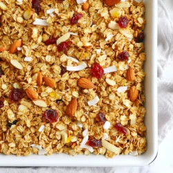 For this Coconut Almond Granola, you need: - 3 cups rolled oats - 1 cup shredded unsweetened coconut - 1 cup almonds, roughly chopped - 1/2 cup honey or maple syrup - 1/4 cup coconut oil, melted - 1 teaspoon vanilla extract - 1/2 teaspoon salt - 1/2 teaspoon cinnamon These ingredients work together to create a crunchy and tasty snack. The oats give you fiber, while the nuts add healthy fats and protein. Coconut brings a tropical flavor that brightens each bite. You can customize your granola with optional ingredients. Consider adding: - 1/2 cup dried fruit (like cranberries or mango) - 1/2 cup seeds (like pumpkin or sunflower) - 1/2 cup nut butter for a richer taste - A pinch of nutmeg for warmth These add-ins not only change the flavor but also boost the nutrition. Dried fruit adds sweetness, and seeds provide extra crunch. Each main ingredient has its own health perks: - Rolled oats: They are full of fiber. This helps with digestion and keeps you full longer. - Almonds: These nuts are rich in vitamin E and healthy fats. They support heart health. - Coconut: It has antioxidants and may help boost energy. - Honey or maple syrup: Both are natural sweeteners. They provide quick energy without refined sugars. - Coconut oil: It contains medium-chain triglycerides. These fats can enhance metabolism. Overall, this granola is not just tasty; it also supports your health with every bite. {{ingredient_image_1}} Start by preheating your oven to 350°F (175°C). Grab a large baking sheet and line it with parchment paper. This step helps the granola not stick. In a big bowl, mix together 3 cups of rolled oats, 1 cup of shredded coconut, 1 cup of roughly chopped almonds, 1/2 teaspoon of salt, and 1/2 teaspoon of cinnamon. Stir until everything is well mixed. In a separate bowl, whisk together 1/4 cup of melted coconut oil, 1/2 cup of honey or maple syrup, and 1 teaspoon of vanilla extract. Make sure these wet ingredients are well combined before moving on. Pour the wet mixture over the dry ingredients. Stir carefully until all the oats and nuts get coated. Then, transfer this mixture to your lined baking sheet. Spread it out evenly and press down lightly to form a compact layer. This helps it bake evenly. Now, bake in the preheated oven for 20 to 25 minutes. Remember to stir halfway through to ensure even browning. Keep an eye on it to avoid burning. You want it golden brown and fragrant. Once the granola is baked, take it out and let it cool completely on the baking sheet. This cooling time is key for that crunchy texture. After it cools, you can add 1/2 cup of dried fruit, like cranberries or mango, if you like. Stir it in well. To store your granola, transfer it to an airtight container. It will stay fresh for up to two weeks. Enjoy your tasty and healthy snack! To get the best texture, watch your granola bake. Aim for a golden brown color. Stir it halfway through baking. This helps it toast evenly. If it smells great, it’s likely done. Let it cool completely on the baking sheet. Cooling makes it crunchy. You can swap honey with maple syrup for a vegan treat. Use sunflower oil instead of coconut oil, if needed. Almonds can change too; try walnuts or pecans. If you don’t like coconut, leave it out. Add more oats to keep the texture. Enjoy this granola in many ways. Serve it with yogurt for a quick breakfast. Mix it into smoothies for added crunch. Top your favorite ice cream for a tasty dessert. You can also snack on it straight from the jar. The options are endless! Pro Tips Use Fresh Ingredients: Always opt for fresh nuts and dried fruits for the best flavor and nutritional value in your granola. Adjust Sweetness: Feel free to adjust the amount of honey or maple syrup based on your personal preference for sweetness. Experiment with Spices: Besides cinnamon, consider adding nutmeg or cardamom for an extra layer of flavor in your granola. Storage Tip: Store your granola in an airtight container to maintain its crunchiness and freshness for longer. {{image_2}} You can change the flavors of your Coconut Almond Granola for the seasons. In the fall, add pumpkin spice. Use pumpkin puree or toasted pumpkin seeds. For winter, try adding cocoa powder and chocolate chips. In spring, mix in fresh berries or citrus zest. Summer is perfect for tropical flavors. Add dried pineapple or coconut flakes for a beach vibe. Granola is fun to customize with different nuts and seeds. If you don’t like almonds, try walnuts or pecans. Cashews add a creamy taste. For seeds, sunflower or pumpkin seeds work well. You can also add chia or flax seeds for extra nutrition. Change these up to match your taste. If you need a gluten-free granola, use certified gluten-free oats. Most oats are naturally gluten-free, but cross-contamination can happen. Check labels to be safe. You can also try replacing honey with agave syrup for a vegan option. This way, you can enjoy a tasty snack without worry. To keep your Coconut Almond Granola fresh, store it in an airtight container. Glass jars or plastic containers work well. Keep the granola in a cool, dry place. Avoid heat or moisture, as they can make it soggy. You can also separate it into smaller bags for easy snacking. Your granola will stay fresh for up to two weeks when stored properly. After that, it may lose its crunch. Signs of spoilage include a stale smell or a soft texture. If you see any mold, throw it away immediately. Always trust your senses when checking for freshness. If your granola goes stale, don’t worry! You can easily revive it. Preheat your oven to 300°F (150°C). Spread the granola on a baking sheet. Bake for about 5-10 minutes. This will bring back the crunch. Just keep an eye on it to avoid burning. Enjoy your tasty snack again! Yes, you can. Use maple syrup instead of honey. It adds sweetness and flavor. Both options work great with the oats and nuts. To make this granola vegan, replace honey with maple syrup. Also, ensure that the coconut oil is plant-based. This keeps the recipe vegan-friendly while still tasting amazing. You can use olive oil or avocado oil in place of coconut oil. Both will help bind the granola and add healthy fats. Keep in mind that the taste may change slightly. You can find store-bought Coconut Almond Granola at most grocery stores. Look in the cereal or snack aisle. Health food stores often carry brands that focus on natural ingredients. You learned how to make tasty Coconut Almond Granola from scratch. We covered key ingredients, steps to bake, and tips for perfecting it. Remember to play with flavors and try seasonal variations. Storing your granola properly keeps it fresh and crunchy. Making your own granola is simple. You control the taste and health benefits. Enjoy your homemade treat and customize it as you like!