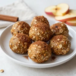 To make delicious Apple Cinnamon Energy Bites, you need these simple ingredients: - 1 cup rolled oats - 1/2 cup almond butter (or peanut butter) - 1/2 cup finely chopped dried apples - 1/4 cup honey or maple syrup - 1 teaspoon cinnamon - 1/2 teaspoon vanilla extract - 1/4 cup ground flaxseed (optional) - 1/4 cup mini chocolate chips or chopped nuts (optional) These ingredients create a tasty and healthy snack. Rolled oats give you energy. Almond butter adds protein and healthy fats. Dried apples bring natural sweetness and flavor. Honey or maple syrup adds a bit of extra sweetness. Cinnamon gives a warm, comforting taste. Vanilla extract enhances all the flavors. Ground flaxseed is optional but adds fiber and omega-3s. Lastly, mini chocolate chips or nuts can make each bite even more delightful. When you gather these items, you set the stage for a fun cooking adventure. Each ingredient plays a role in making these bites both yummy and good for you. {{ingredient_image_1}} Start by gathering your ingredients. You need rolled oats, almond butter, dried apples, honey, cinnamon, vanilla extract, and optional ground flaxseed. - Combine all ingredients in a large mixing bowl. - Mix until everything is well combined. - If the mix seems too dry, add a splash of water or more almond butter. - Fold in any optional ingredients like mini chocolate chips or chopped nuts for extra flavor. Now it’s time to shape your energy bites. - Scoop out about 1 tablespoon of the mixture. - Roll it into a ball using your hands. - Repeat until you use all of the mixture. - Place the rolled bites on a parchment-lined baking sheet. To make sure your energy bites firm up, follow these steps. - Refrigerate the bites for 30 minutes. - After they are set, transfer them to an airtight container for storage. - You can keep them in the fridge for up to a week, or freeze them for longer freshness. If you want to switch things up, you can use peanut butter instead of almond butter. Peanut butter gives a nice, creamy taste. If you prefer a vegan option, choose maple syrup instead of honey. Both choices keep the bites sweet and tasty. Sometimes, you may want your bites to be extra sticky. You can add more almond butter or a splash of water to the mix. This helps bind the ingredients together better. Ground flaxseed is another great option to improve texture. It adds nutrition and helps hold the bites together nicely. How you serve your energy bites can make a big difference. You can place them in a mason jar for a fun look. A decorative plate also works well. For a pretty touch, sprinkle some cinnamon on top. Fresh apple slices can add color and freshness to your snack display. Pro Tips Customize Your Sweetness: Adjust the amount of honey or maple syrup based on your sweetness preference. You can also substitute with a sugar-free sweetener if desired. Experiment with Mix-Ins: Feel free to add other ingredients like shredded coconut, chia seeds, or different nuts to enhance the flavor and texture of your energy bites. Storage Tips: For longer shelf life, freeze the energy bites. They can be enjoyed straight from the freezer for a refreshing snack. Perfect Portioning: Use a small cookie scoop for uniform sizes when rolling the bites. This ensures even texture and makes them easy to grab for a quick snack. {{image_2}} You can change the flavor of your energy bites easily. Try adding dried fruits like cranberries or apricots. These fruits give a sweet and chewy texture. You can also use spices like nutmeg or ginger for a fun twist. These spices add warmth and depth to the bites. If you need a gluten-free option, use certified gluten-free oats. This simple swap keeps the bites safe for those with gluten sensitivities. Want a nut-free version? Just switch to sunflower seed butter. This option keeps the bites tasty and safe for nut allergies. To boost nutrition, consider adding chia seeds or protein powder. Chia seeds add fiber and healthy fats. Protein powder gives an extra boost to keep you full longer. You can also mix in coconut flakes for added flavor and texture. They add a chewy bite that makes these snacks even more enjoyable. Store your Apple Cinnamon Energy Bites in the fridge. They stay fresh for up to a week. Use airtight containers. This helps keep them moist and tasty. To freeze your energy bites, place them in a single layer on a baking sheet. After they freeze, move them to a freezer-safe bag. This gives you longer shelf life. When you want to eat them, take a few out. Let them thaw in the fridge overnight or at room temperature for a couple of hours. The ideal portion size is about one bite. This snack is great for energy. You can enjoy one before exercise or as an afternoon treat. Yes, you can make these energy bites ahead of time. They are perfect for meal prep. After making them, store them in an airtight container. They last up to one week in the fridge. If you need them for longer, freeze them. In the freezer, they can stay fresh for up to three months. Just remember to thaw them in the fridge before enjoying. These energy bites pack a punch of nutrition. Here are some key nutrients: - Fiber: Rolled oats and dried apples provide good fiber. This helps digestion and keeps you full. - Protein: Almond butter adds protein, which is great for muscle health. - Healthy Fats: Almond butter and flaxseed offer healthy fats. These are essential for heart health. - Natural Sweetness: Honey or maple syrup gives a sweet taste without refined sugars. These bites are a smart choice for a quick energy boost. Absolutely! You can change the flavor to suit your taste. Here are some ideas: - Different Dried Fruits: Use cranberries or apricots for a fruity twist. - Spices: Add nutmeg or ginger for extra warmth and flavor. - Nut Alternatives: Swap almond butter for sunflower seed butter if you need a nut-free option. - Chocolate: Use dark chocolate chips for a richer taste. Feel free to get creative and make these bites your own! In this blog, I shared how to make tasty energy bites with simple ingredients. You learned the steps to mix, roll, and chill these snacks. I also covered tips to customize flavors and store them properly. These energy bites pack nutrition and flavor into a fun snack. Whether you need a quick boost or a healthy treat, these bites are great. Try different ingredients to make them your own. Enjoy creating and sharing these easy snacks!